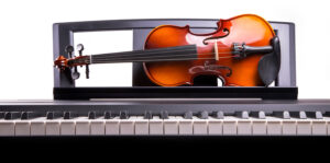 violin on the desk electronic piano e1612892058135